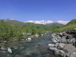 Hida Mountains, Northern Alps and melted snow melted snow river / Hakuba, Nagano Prefecture, Japan  Stock Footage