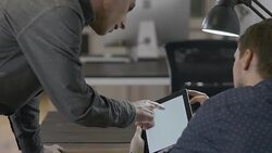 Two young entrepreneur businessmen working late in the office Stock Footage