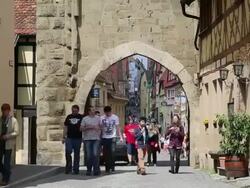 Rothenburg ob der Tauber, people walking through the Siebers tower Stock Footage