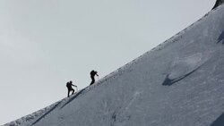 Climbers on the arete leading up from the Vallee Blanche to the Aiguille Du Midi above Chamonix, France Stock Footage