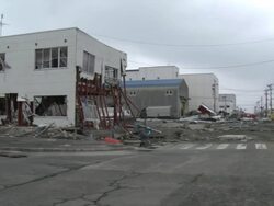 Destruction caused by tsunami after magnitude 9 Tohoku earthquake, north east Japan, March 2011. Pan across wrecked street from tsunami in Ishinomaki City port, Miyagi Prefecture Stock Footage