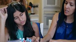Mother explaining science homework while home schooling preteen daughter Stock Footage