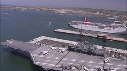 A cruise ship moors near the USS Midway CV-41 in San Diego, California. Stock Footage