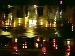 WS Reflections on river as floating offering candles float past Stock Footage