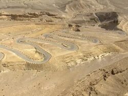 Aerial winding road in desert, Negev, Israel Stock Footage
