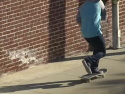 A young man skateboarding on the sidewalk.  - Slow Motion Stock Footage