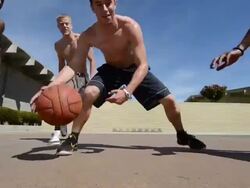 DS TS Dolly of male basketball players showing off and dribbling the basketball. Stock Footage