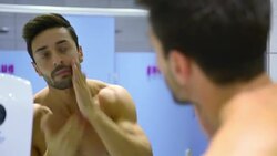 Young man taking care of his face in gym's locker room Stock Footage