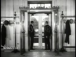 1936: U.S. WHITE HOUSE: HALLS: WS White House driveway. INT MS Guards, servants (possibly Secret Service) at door. MS U.S. Seal on floor. VS Servants walking in hall, pass large mirror. MS Portrait of Ex President Woodrow Wilson. Washington D.C. Instructional Video