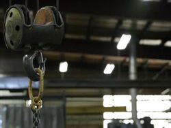 MS TU Hook of crane lifting chain in factory / Seattle, Washington, United States Stock Footage