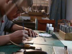 leatherworker paint fish pattern on leather Stock Footage