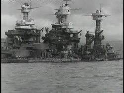 U.S. military ships explode and airplanes become rubble as the Japanese attack Pearl Harbor. Stock Footage