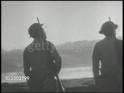 1942: MIDWAY ISLAND U.S. AIR BASE: VS United States Marines on guard, on lookout along coast of Midway Island. MS Silhouette of soldier standing watch, dock & waters BG. Battle of Midway, World War II, WWII, Pacific Front Instructional Video