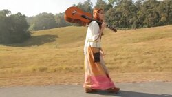 Hippie woman walking on the road Stock Footage