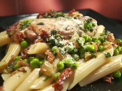MS DS Parmesan cheese sprinkled over chicken penne dish / Los Angeles, California, United States Stock Footage