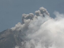 Ash erupts from top of Merapi volcano into clear blue sky; Central Java, Indonesia. 29 October 2010 Stock Footage