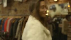 friends looking at smart phone and filming friends while they try on clothes and pose Stock Footage