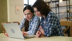 Two beautiful girls with laptop Stock Footage