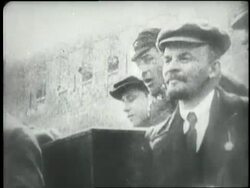 Vladmir Lenin stands with other men. News Clip