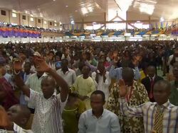 WS ZI View of large crowd of people praying in church, holding arms up / Lagos, Nigeria Stock Footage