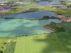 WS AERIAL View of farmland and small towns with ponds near town / Germany Stock Footage