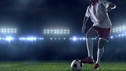 Soccer player dribbling a ball on the field Stock Footage