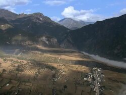 WS PAN Shot over towns with fields and mountains on Tibetan Plateau / Qinghai Province, China Stock Footage
