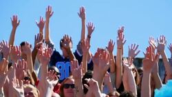 MS Crowd of football fans in stadium waving hands in air Stock Footage