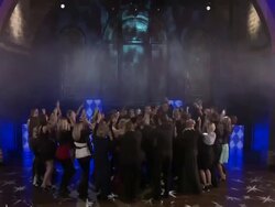 TILT DOWN WS Bride and groom and wedding party dance in center of ring of other dancers Stock Footage