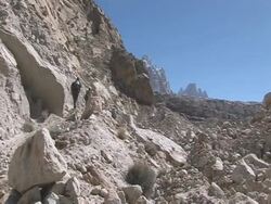 Group climbing up side of glacial mountain, Himalayas Stock Footage