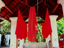MS Shot of saffron monk's clothes hang for drying and one monk reading / Luang Prabang, Laos Stock Footage