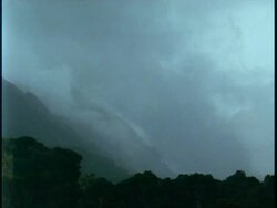 WA fog swirling around amongst jungle covered mountains, Uganda, Africa Stock Footage