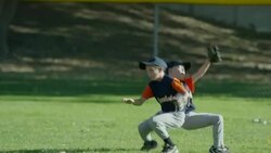 Medium shot of boys colliding in baseball game / American Fork, Utah, United States Stock Footage