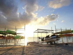 WS View of sun setting at the beach with paddle surfing board / Chatan, Okinawa, Japan Stock Footage