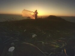 MS SLO MO POV Woman with cape in wind by Ocean at sunset / Cape Blanco, Oregon, United States Stock Footage