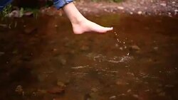 Bare feet of a woman. river water. Stock Footage