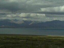 Pan right Mansarovar Lake with mountains Lhasa Tibet China Stock Footage