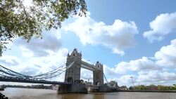 Traffic moves across Tower Bridge in London. Stock Footage