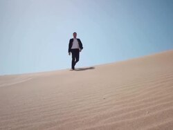 Businessman in desert Stock Footage