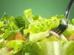 ECU fork lifts a bite from mixed green salad  Stock Footage