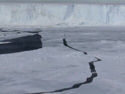 WS Large crack through sea ice and Tabular iceberg in distance / Antarctica Stock Footage