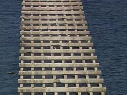 Aerial over Interstate 90 bridge destroyed by Hurricane Katrina over Bay of St. Louis / Waveland, medium shot Stock Footage