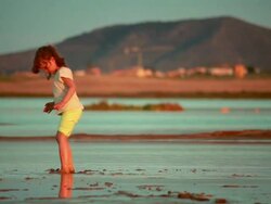 Small child playing in the mud. Stock Footage
