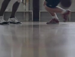 MS Two different pairs of mens feet playing basketball in  gymnasium / Minneapolis, Minnesota, United States  Stock Footage