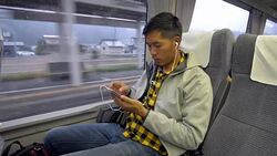 A Man using smartphone in train Stock Footage