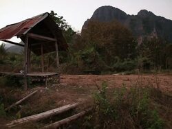 WS People moving on bike and bicycle on road near mountain /  Vang Vieng, Vientiane, Laos Stock Footage