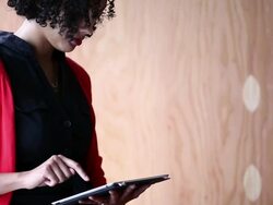 MS TU Businesswoman sitting in office working on digital tablet/Washington, USA Stock Footage