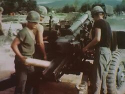 Soldier loads large, ground-mounted gun during Vietnam War Stock Footage