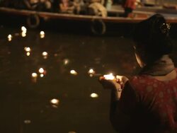 MS TU TD Woman putting offerings into Ganges river / Varanasi, India Stock Footage