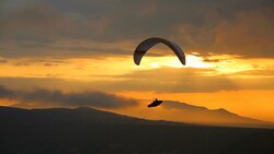 Paraglider silhouette at sunset Stock Footage